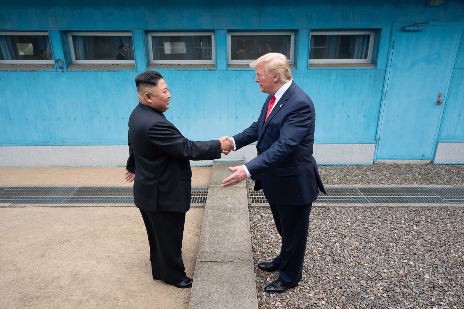 Trump shakes hands with North Korean leader Kim Jong Un as the two <a href="index.php?page=&url=https%3A%2F%2Fwww.cnn.com%2F2019%2F06%2F30%2Fworld%2Fgallery%2Ftrump-kim-north-korea%2Findex.html" target="_blank">meet at the Korean Demilitarized Zone</a> in June 2019. Trump briefly stepped over into North Korean territory, becoming the first sitting US leader to set foot in the nation. Trump said he invited Kim to the White House, and both leaders agreed to restart talks after nuclear negotiations stalled.