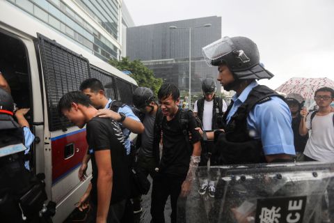 Police detain protesters near the government headquarters in Hong Kong on July 1.
