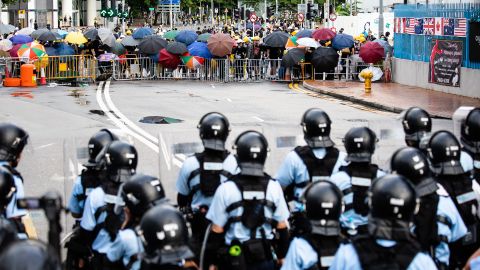 Demonstrators stand off against riot police early Monday.