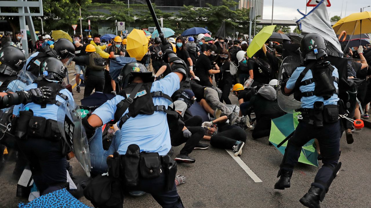 Riot police try to disperse protesters on the anniversary of Hong Kong's handover to China.