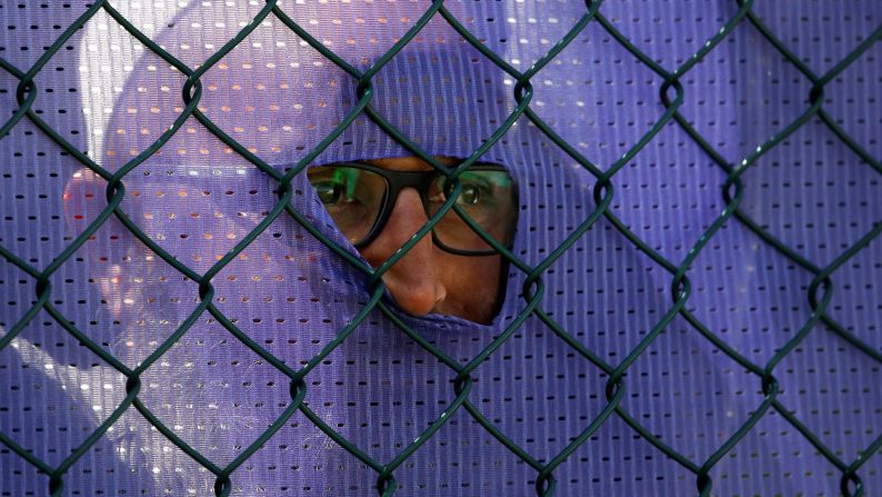 A fan looks through the fence during a Cricket World Cup match between India and Britain on Friday, June 29.