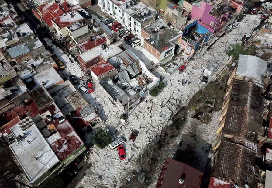 An aerial view of vehicles buried in ice.
