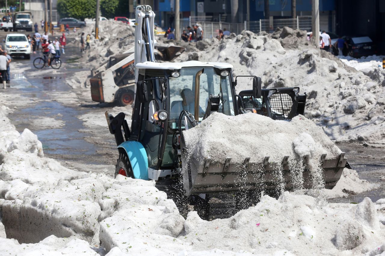 A truck carries away ice as it cleans a street.