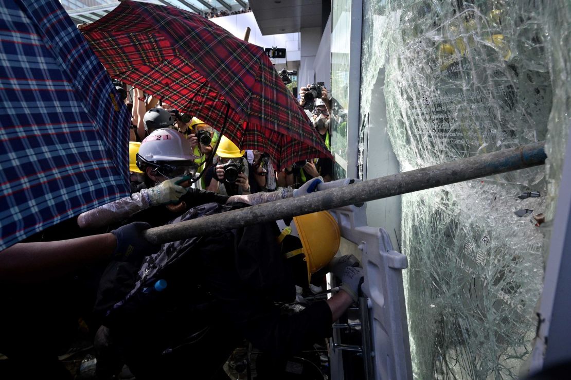 Protesters attempt to break a window at the government headquarters in Hong Kong on July 1.