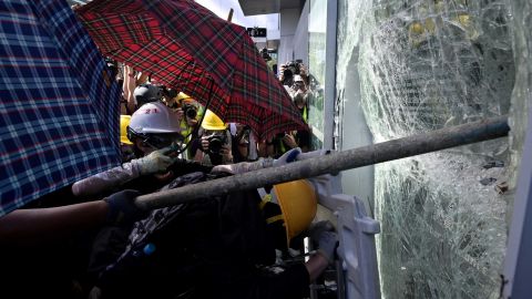 Protesters attempt to break a window at the government headquarters in Hong Kong on July 1.