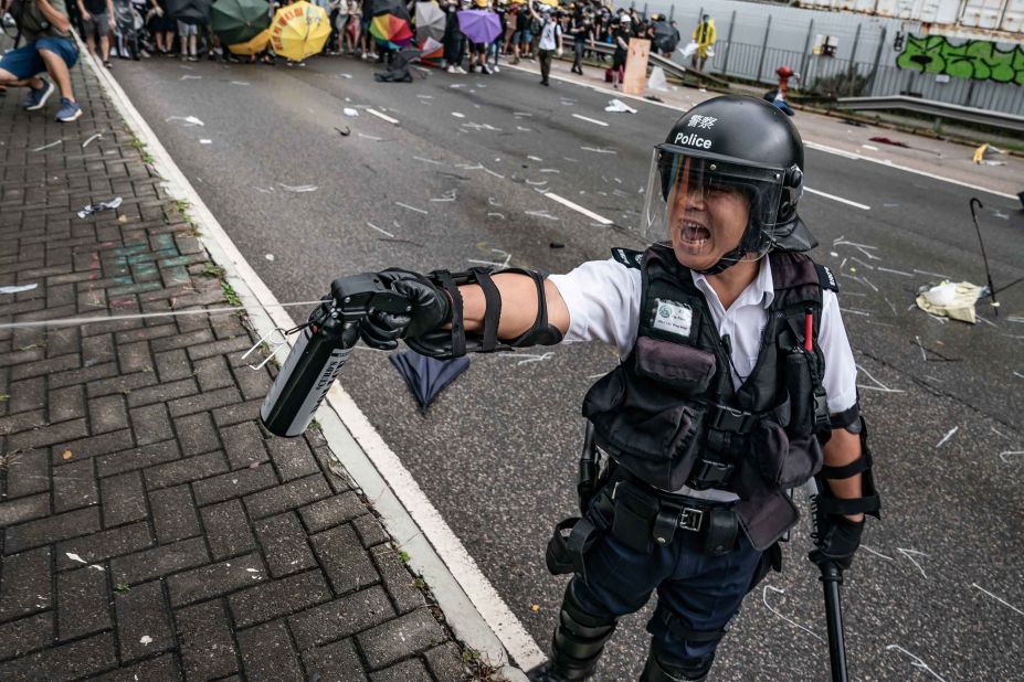 A police officer uses pepper spray during a clash with protesters on July 1.