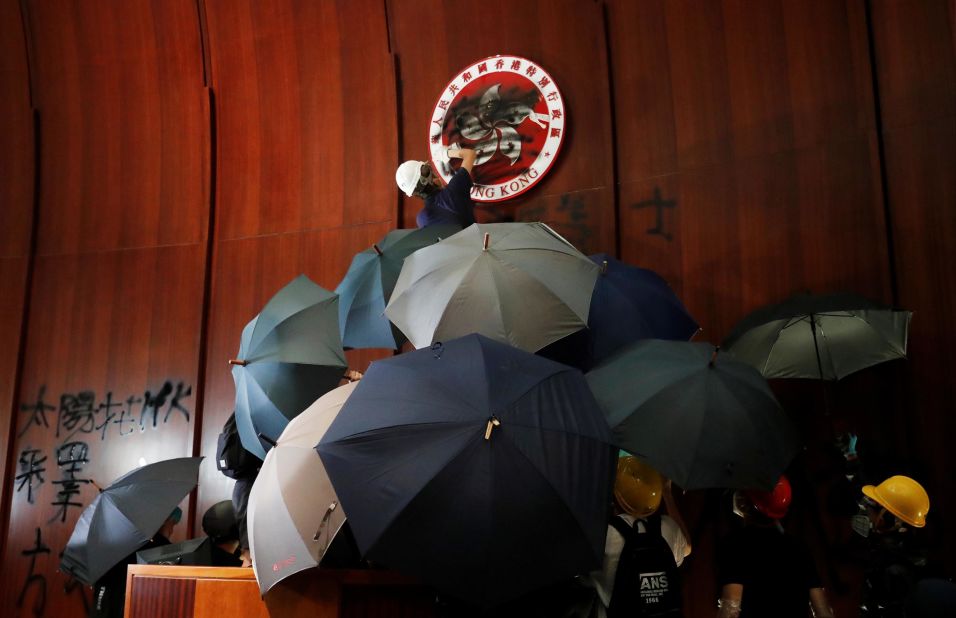 A demonstrator sprays paint inside a chamber at Hong Kong's Legislative Council building, where protesters forced their way in on Monday, July 1.