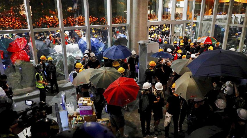 Protesters get inside the Legislative Council after they staged a rally in Hong Kong, Monday, July 1, 2019. Combative protesters are staging a protest outside the Hong Kong legislature as a crowd of thousands prepares to start a march in that direction.(AP Photo/Vincent Yu)