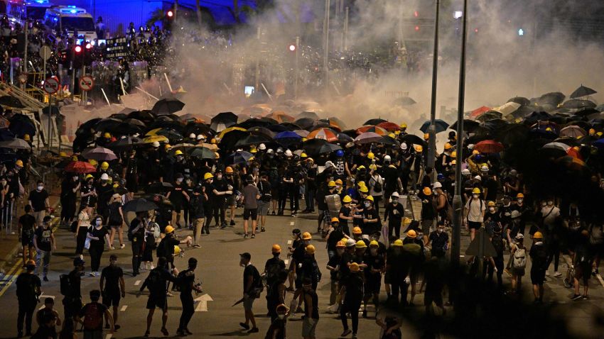 Police fire tear gas at protesters near the government headquarters in Hong Kong on July 2, 2019, on the 22nd anniversary of the city's handover from Britain to China. - Hundreds of protesters stormed Hong Kong's parliament late on July 1 as the territory marked its China handover anniversary, ransacking the building and daubing its walls with graffiti as the city plunged into unprecedented depths of political chaos. (Photo by Anthony WALLACE / AFP)        (Photo credit should read ANTHONY WALLACE/AFP/Getty Images)