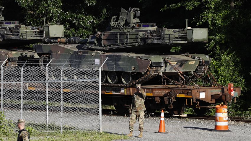 Military police walk near Abrams tanks on a flat car in a rail yard, Monday, July 1, 2019, in Washington, ahead of a Fourth of July celebration that President Donald Trump says will include military hardware. (AP Photo/Patrick Semansky)