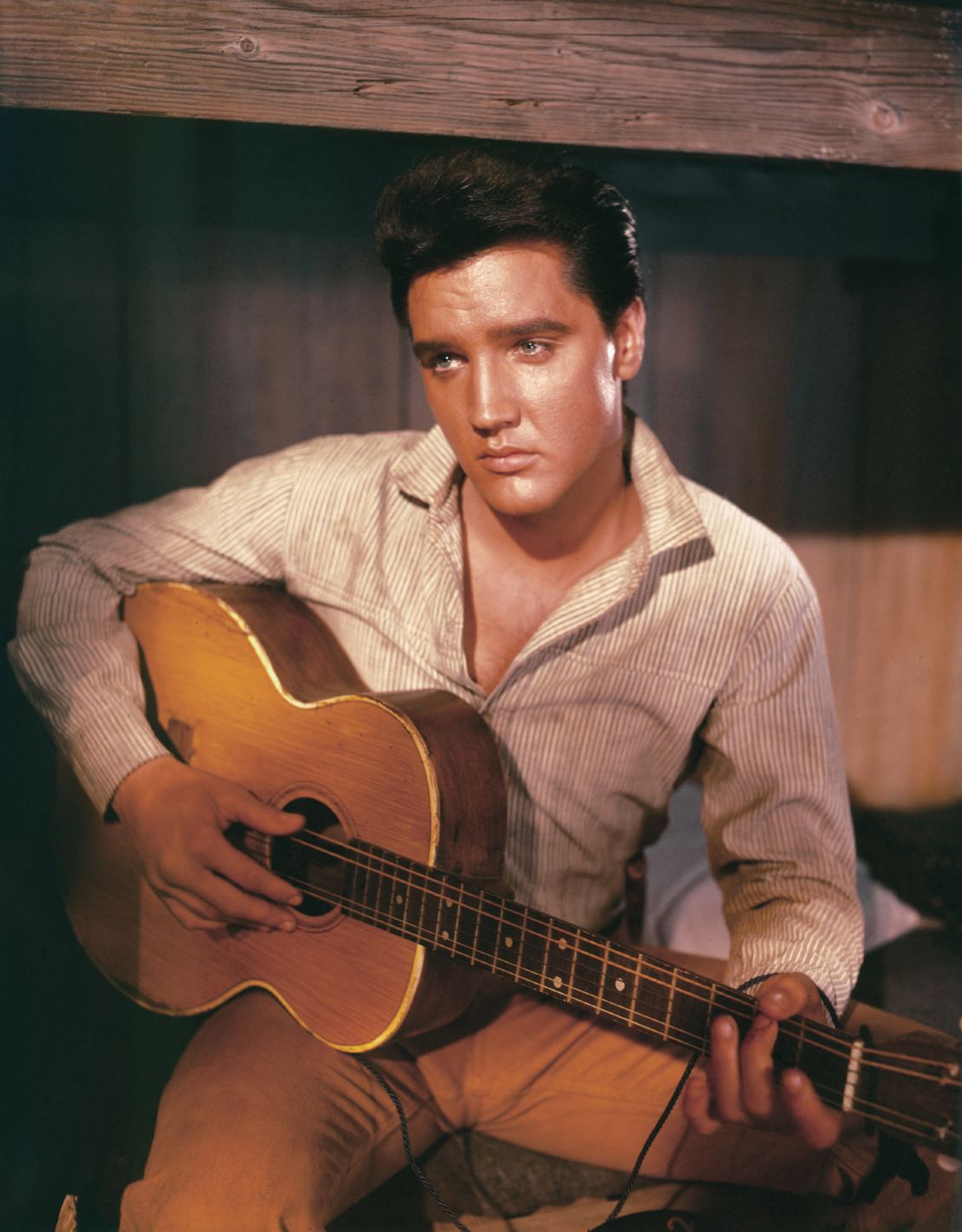 Who can resist this portrait of Elvis Presley holding an acoustic guitar, circa 1956?