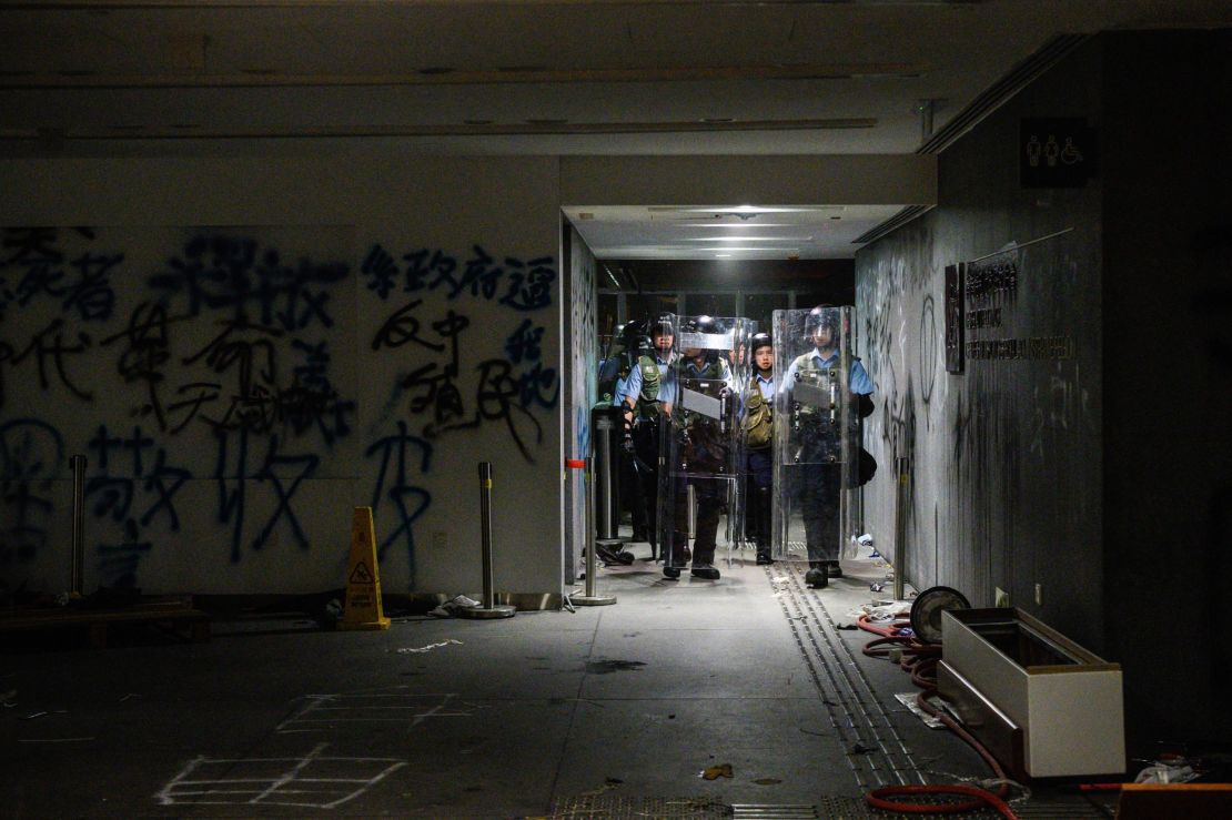Police arrive after protesters stormed the government headquarters hours before in Hong Kong early on July 2, 2019.