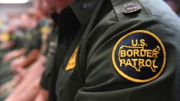 A US Customs and Border patrol agent looks on as US President Donald Trump speaks during  a roundtable on immigration and border security at the US Border Patrol Calexico Station in Calexico, California, April 5, 2019. - President Donald Trump landed in California to view newly built fencing on the Mexican border, even as he retreated from a threat to shut the frontier over what he says is an out-of-control influx of migrants and drugs. (Photo by SAUL LOEB / AFP)        (Photo credit should read SAUL LOEB/AFP/Getty Images)