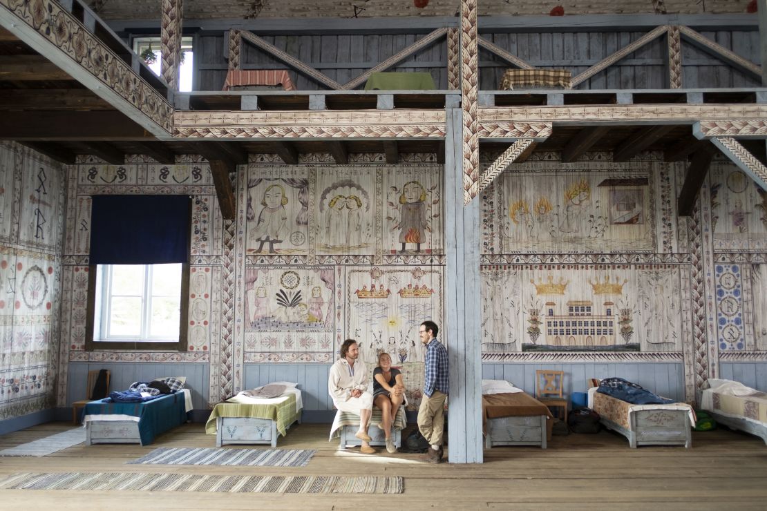 Actors Vilhelm Blomgren and Florence Pugh with writer-director Ari Aster on the set of "Midsommar."