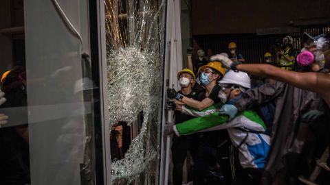 Protesters smash glass doors and windows to break into the parliament chamber of Legislative Council Complex on July 1.