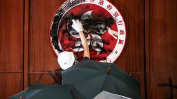 A protester defaces the Hong Kong emblem after protesters broke into the government headquarters in Hong Kong on July 1, 2019, on the 22nd anniversary of the city's handover from Britain to China.