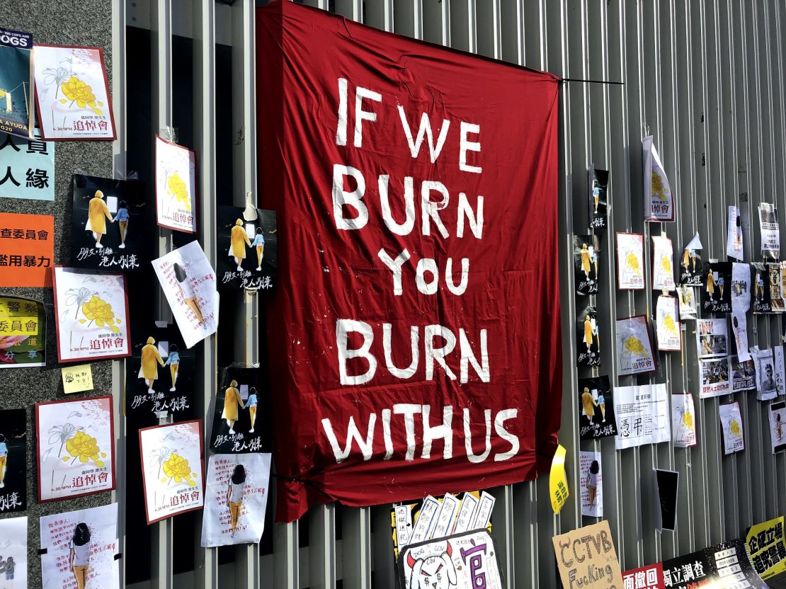 A flag reading "If we burn, you burn with us," erected outside Hong Kong's legislature on July 1, 2019.