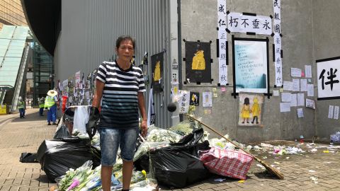 Volunteer cleaner Liu Yuk-lin, 57, collects waste around Hong Kong's Legislative Council building on July 2, 2019, left behind from a protest the day before.