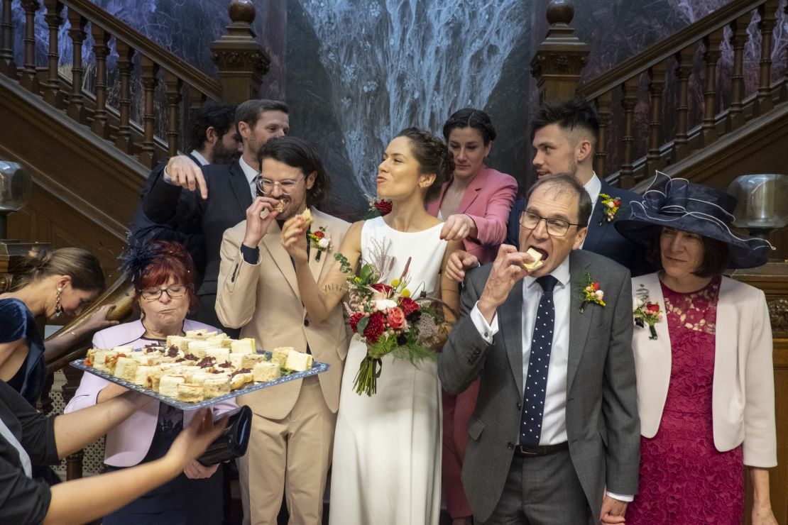 A hungry wedding party bites into canapes -- the type of moment usually left out of wedding photos.