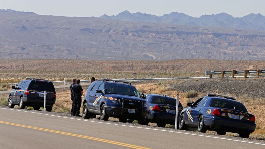 Nevada Highway Patrol officers gather to support federal law enforcement personnel as they block access to thousands of acres of Bureau of Land Management (BLM) land that have been temporarily closed so they can round up illegal cattle that are grazing, south of Mesquite, Nevada, April 7, 2014. Armed U.S. rangers are rounding up cattle on federal land in Nevada in a rare showdown with Cliven Bundy, a rancher who has illegally grazed his herd on public lands for decades, as conflict over land use simmers in western states. Picture taken April 7, 2014. REUTERS/George Frey (UNITED STATES - Tags: SOCIETY CRIME LAW ENVIRONMENT ANIMALS)