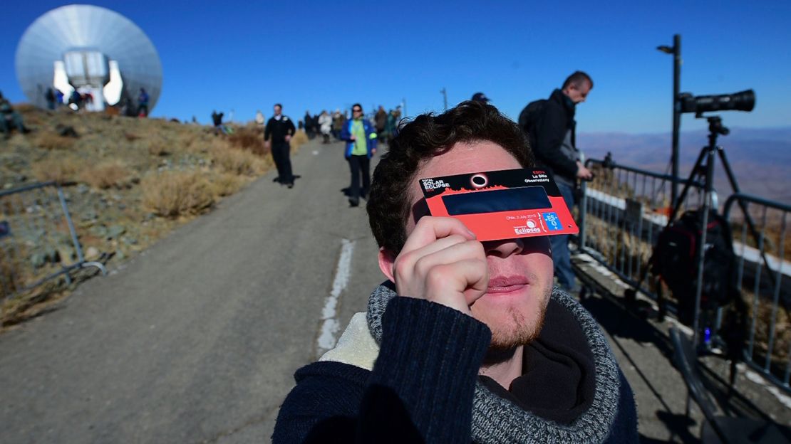 A tourist tries special glasses at Chile's La Silla European Southern Observatory ahead of the eclipse.