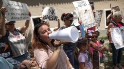 epa07690389 Irene Martinez (L) shouts slogans next to few Immigration activists to demand the end of the migrant detention centers in the US, in front of Senator Marco Rubio's office building in Miami, Florida, USA, 02 July 2019. Over 170 demonstrations named #CloseTheCamps are taking place across the country, including cities like Miami, New York, Los Angeles and in border communities.  EPA/CRISTOBAL HERRERA