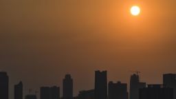 The morning sun rises past buildings and haze over the Jakarta city skyline on August 17, 2018. - Indonesia is about to open the Asian Games but its traffic-clogged capital Jakarta remains shrouded in a haze of air pollution that threatens to mar the world's second-biggest multi-sport event. (Photo by BAY ISMOYO / AFP)        (Photo credit should read BAY ISMOYO/AFP/Getty Images)