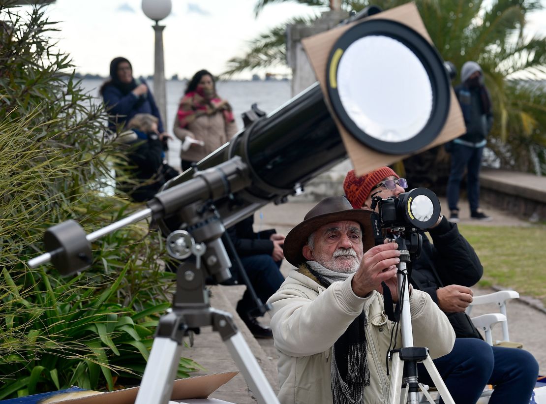 A man takes pictures of a total solar eclipse in Chascomus, Argentina.