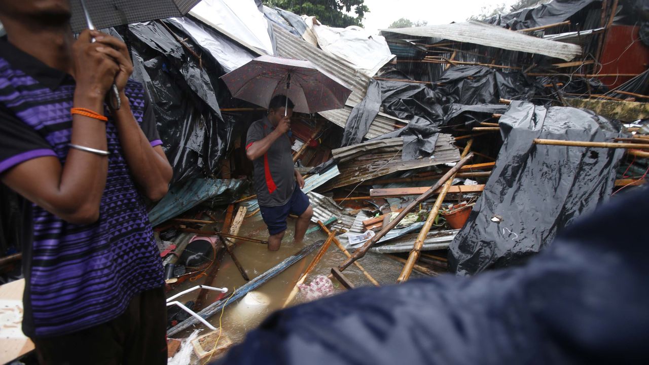 Shanty homes lay in ruins on Tuesday after a wall collapsed on them in Mumbai.