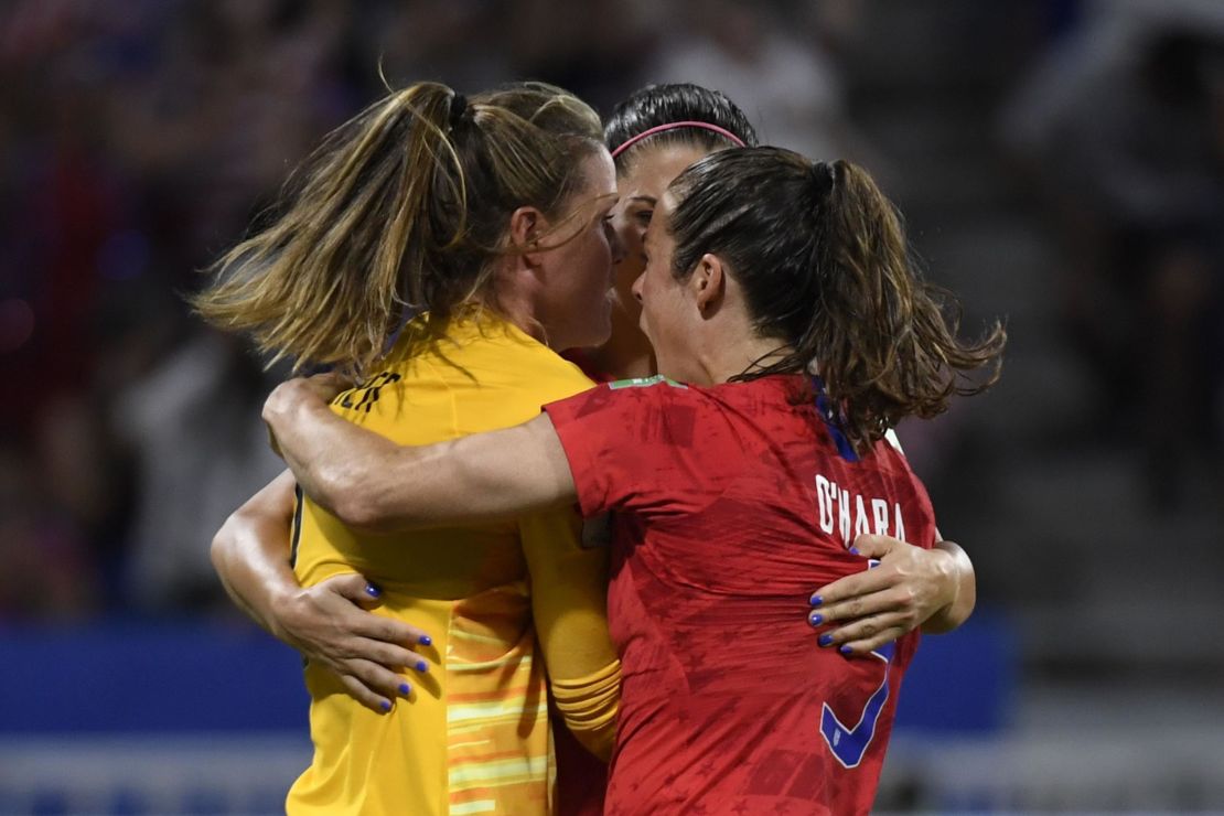 United States goalkeeper Alyssa Naeher is mobbed by teammates after her crucial penalty save.