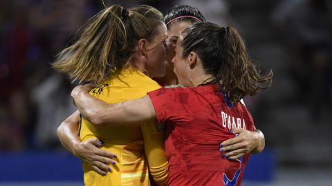 United States goalkeeper Alyssa Naeher is mobbed by teammates after her crucial penalty save.