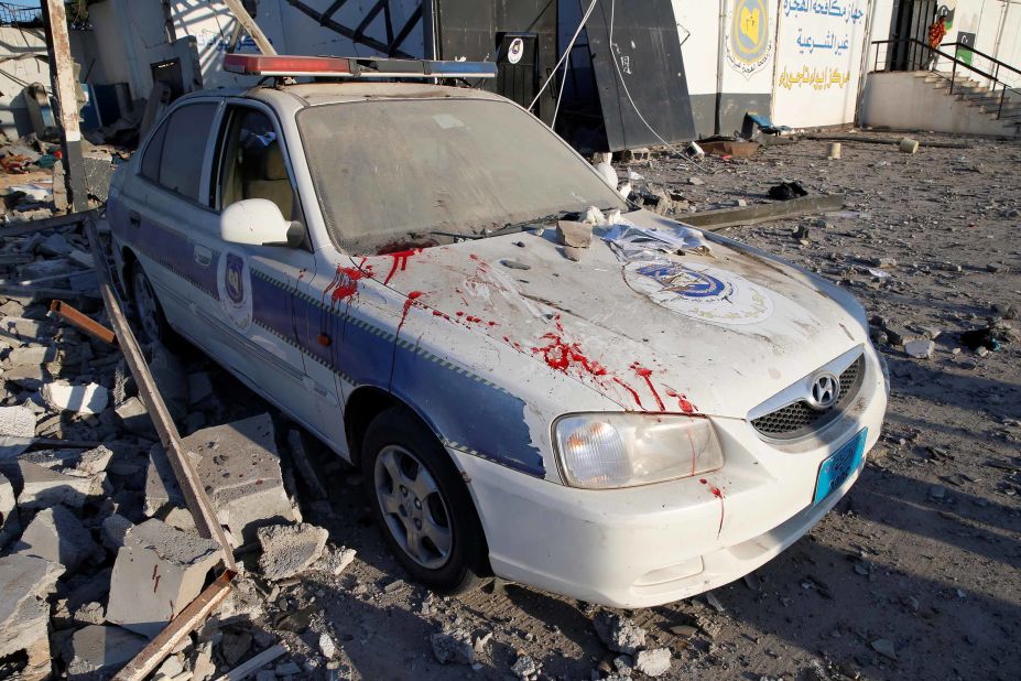Bloodstains are seen on a police car at the scene of the airstrike on the migrant detention center.