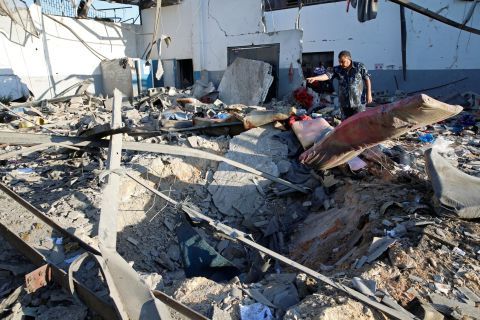 A policeman is seen at the site of an airstrike which hit a migrant detention center in the Tajoura suburb of the Libya's capital, Tripoli, on Wednesday, July 3.