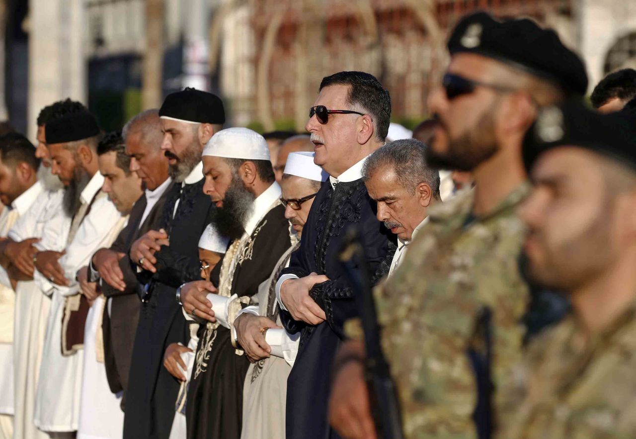 Government of National Accord Prime Minister Fayez al-Sarraj, fourth from right, performs Eid al-Fitr prayers at Martyrs Square in Tripoli on June 4.