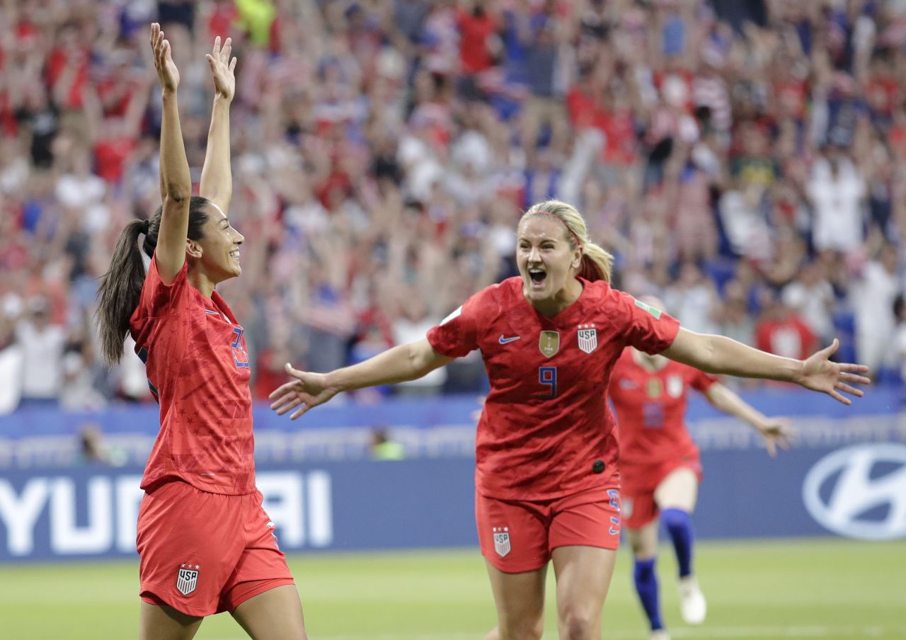 Christen Press, left, celebrates her opening goal against England with Lindsey Horan. Press was the surprise starter in place of Rapinoe.