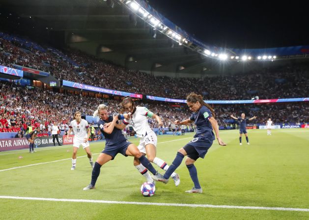 Morgan is challenged by French players Amandine Henry, left, and Amel Majri.