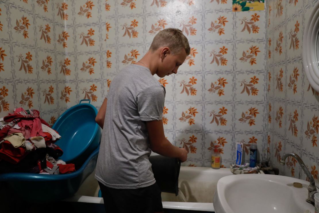 Edik, 13, used to play ball after school but since the conflict started, he collects and carries water from the pump to help his family living in eastern Ukraine.