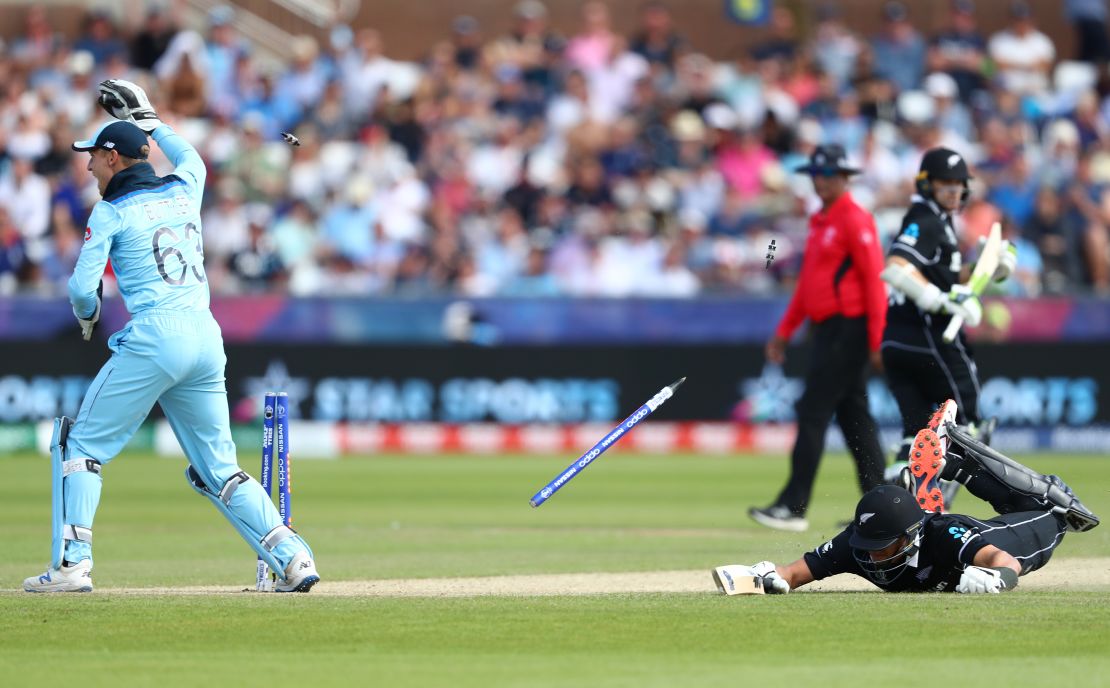 Ross Taylor of New Zealand is run out as Jos Buttler breaks the stumps after a throw from Adil Rashid.