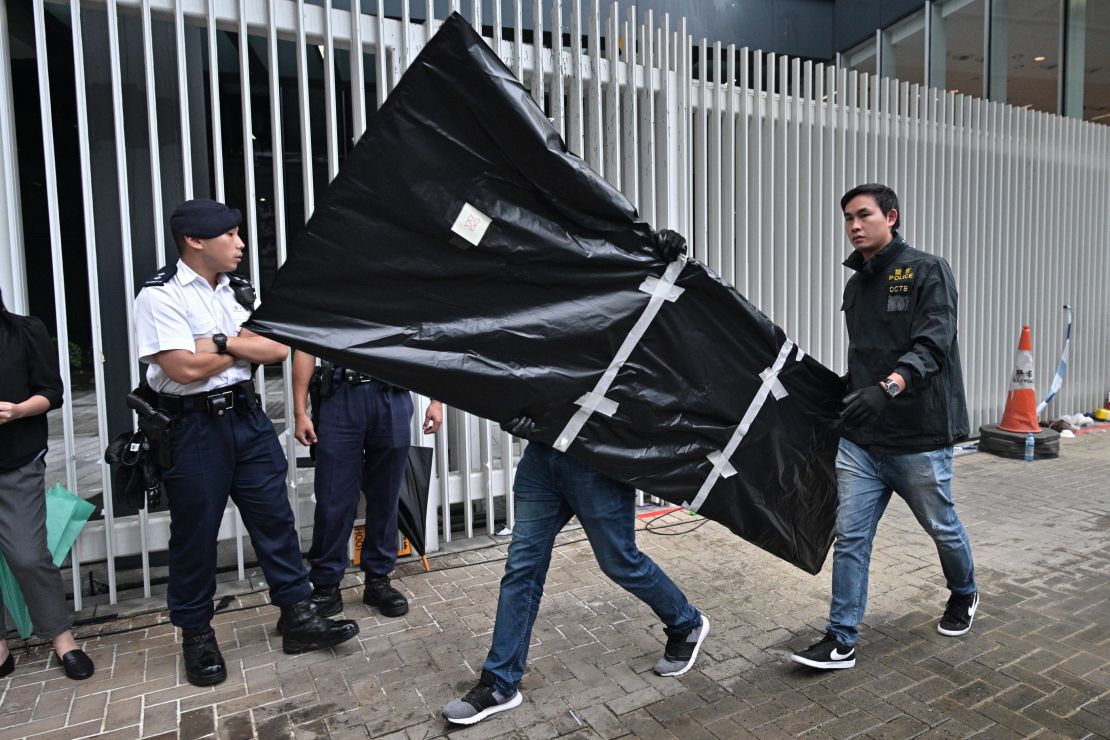 Police carry evidence out of the Legislative Council in Hong Kong on July 3, 2019, two days after protesters broke into the complex.