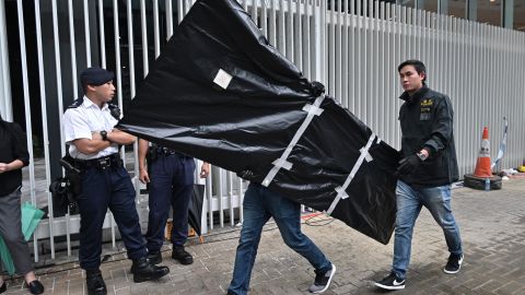 Police carry evidence out of the Legislative Council in Hong Kong on July 3, 2019, two days after protesters broke into the complex.