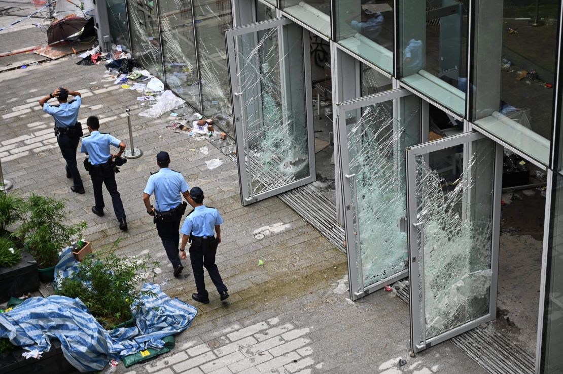 Police walk next to the Legislative Council building in Hong Kong on July 2, 2019. 