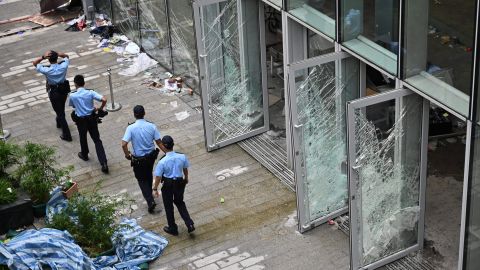 Police walk next to the Legislative Council building in Hong Kong on July 2, 2019.