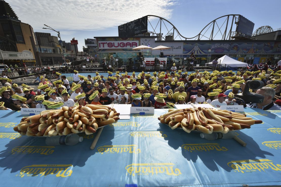 Fans wear themed foam hats as they attend the 2019 Nathan's Famous Fourth of July Hot Dog Eating Contest in Brooklyn. (Photo by Anthony Behar/Sipa USA)(Sipa via AP Images)