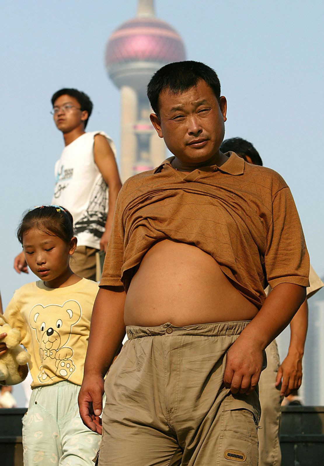 Residents outside as temperatures soar in Shanghai, August 4, 2005. 