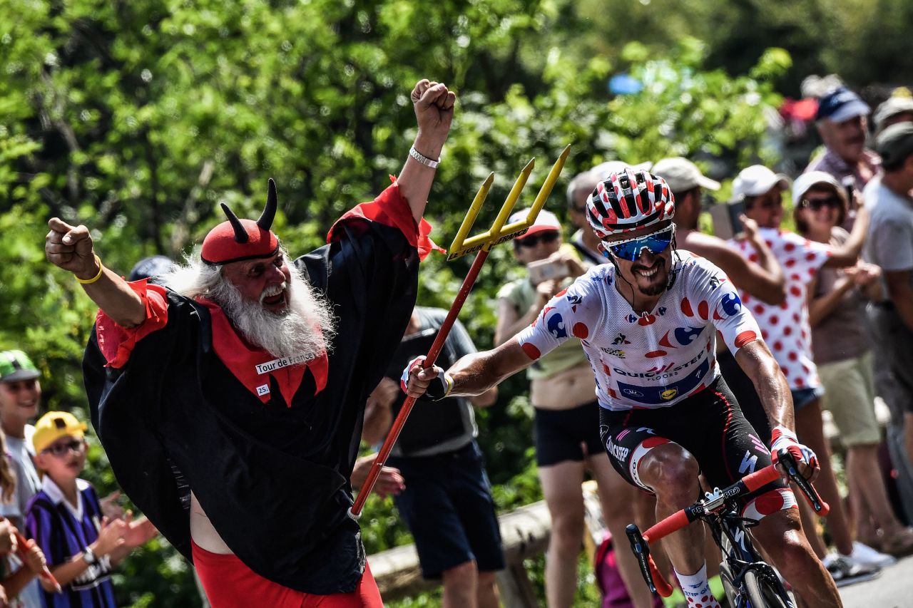 France's Julian Alaphilippe, wearing the best climber's polka dot jersey, seizes the fork of legendary Tour de France fan Didi Senft, nicknamed "The Devil," during the 17th stage of last year's race. "The Devil" is sure ot make his customary appearances this year.