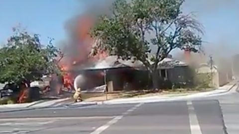 Firefighters battle a house fire in Ridgecrest, California.