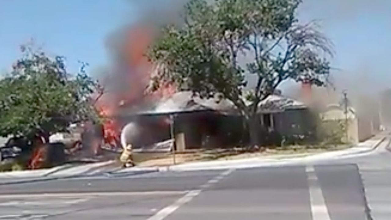 Firefighters battling a house fire in Ridgecrest, California.