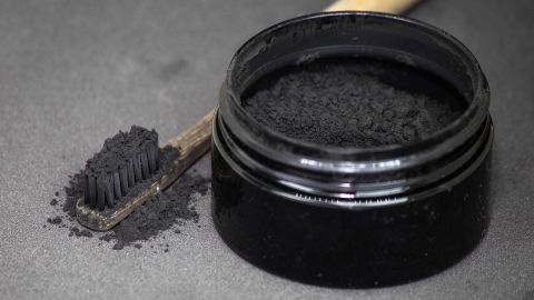 Charcoal on a toothbrush to whiten teeth