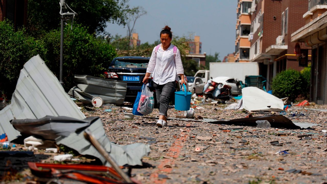 A local resident walks through debris of residential buildings damaged by strong winds, after the tornado.