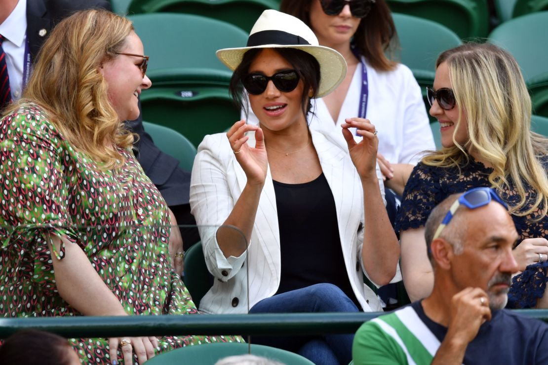 Britain's Meghan, Duchess of Sussex (center) watches Serena Williams at Wimbledon.